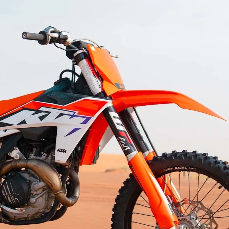 KTM 450 dirt bike on a Dubai desert dune trail — photo 1