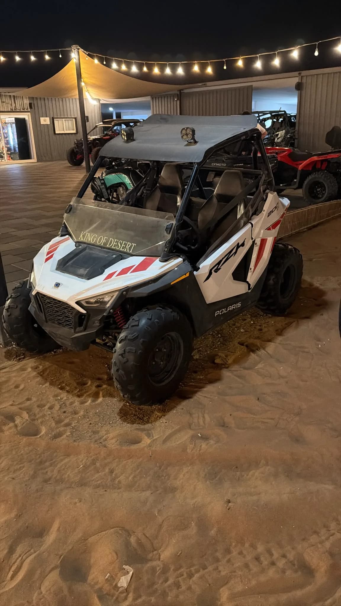 Polaris RZR 200 kids buggy parked in front of the King of Desert camp, Dubai